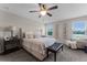 Inviting bedroom featuring a plush bed, accent furniture, and plenty of natural light at 3172 Jade Tree Pt, Oviedo, FL 32765