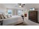 Inviting bedroom features a plush bed, accent furniture, and plenty of natural light at 3172 Jade Tree Pt, Oviedo, FL 32765