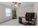 Bright bedroom with a desk, computer setup, and cozy carpet at 3172 Jade Tree Pt, Oviedo, FL 32765