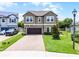 Charming two-story home with a brick driveway and lush green lawn at 3172 Jade Tree Pt, Oviedo, FL 32765