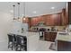 Well-equipped kitchen with granite countertops, stainless steel appliances, and central island with barstool seating at 3172 Jade Tree Pt, Oviedo, FL 32765