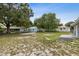 Large backyard featuring a playground, utility shed, and grass area with partial fencing at 325 Little Aspen Ct, Ocoee, FL 34761