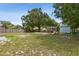 Spacious backyard featuring a playground, storage shed, mature trees, and partial fencing at 325 Little Aspen Ct, Ocoee, FL 34761