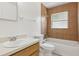 Tiled bathroom features a tub with shower, white fixtures, and a modern sink vanity at 325 Little Aspen Ct, Ocoee, FL 34761