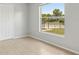 Neutral bedroom with a large window providing natural light and view of the yard at 325 Little Aspen Ct, Ocoee, FL 34761