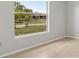 Sunlit bedroom featuring neutral walls, a window with view, and a neutral tile floor at 325 Little Aspen Ct, Ocoee, FL 34761