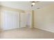 Comfortable bedroom with tile floors, closet, and an open doorway to another room at 325 Little Aspen Ct, Ocoee, FL 34761