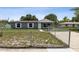 Single-story home with a gray exterior and white trim with a chain-link fence and front yard at 325 Little Aspen Ct, Ocoee, FL 34761