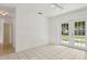 Bright living room featuring tile floors and glass doors leading to the backyard at 325 Little Aspen Ct, Ocoee, FL 34761