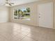 Bright and airy living room featuring tile flooring, a ceiling fan, and a large window at 325 Little Aspen Ct, Ocoee, FL 34761