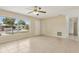 Open living room with tile flooring, ceiling fan, and large window for natural light at 325 Little Aspen Ct, Ocoee, FL 34761