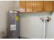 Utility room features a water heater, cabinets, and clean, functional layout at 325 Little Aspen Ct, Ocoee, FL 34761