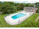 Overhead view of the community pool and picnic tables at this complex near many mature trees at 4312 Lake Underhill Rd # 19-B, Orlando, FL 32803