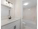 Well-lit bathroom featuring a single sink vanity with sleek fixtures and a shower-tub combination with white marble style tiles at 4312 Lake Underhill Rd # 19-B, Orlando, FL 32803