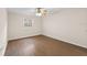 Bedroom with neutral paint, wood floors, and a window for natural light at 4312 Lake Underhill Rd # 19-B, Orlando, FL 32803