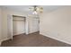 Bedroom with wood flooring, ceiling fan and closet for optimal space at 4312 Lake Underhill Rd # 19-B, Orlando, FL 32803