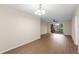 Open living room with wood floors, neutral walls, a decorative chandelier and sliding glass doors to outdoor patio at 4312 Lake Underhill Rd # 19-B, Orlando, FL 32803