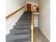 This shows the stairway to the upper units, with wooden handrails and doors to apartments on each level at 4312 Lake Underhill Rd # 19-B, Orlando, FL 32803
