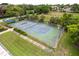 Aerial view of the community tennis courts in a lush green space at 4312 Lake Underhill Rd # 19-B, Orlando, FL 32803
