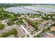 Aerial view of community with mature trees, ample parking, and waterfront views, enhancing its appeal at 4312 Lake Underhill Rd # 19-B, Orlando, FL 32803