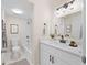 Clean bathroom with white vanity, modern fixtures, mirror, and a shower/tub combo featuring white tile at 4312 Lake Underhill Rd # 19-B, Orlando, FL 32803