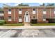 Attractive two-story brick building featuring rows of windows, a decorative entryway, and neat landscaping at 4312 Lake Underhill Rd # 19-B, Orlando, FL 32803