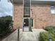 External brick building lift with brick walls and an concrete walkway at 4312 Lake Underhill Rd # 19-B, Orlando, FL 32803