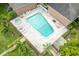 An aerial view captures a large community pool with surrounding lounge chairs and palm trees at 4312 Lake Underhill Rd # 19-B, Orlando, FL 32803