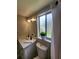 Updated bathroom with a modern vanity, toilet, and frosted glass window providing natural light at 4883 Cherokee Rose Dr, Orlando, FL 32808