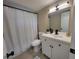 Bathroom with white vanity, new fixtures, shower with curtain, and neutral color scheme at 4883 Cherokee Rose Dr, Orlando, FL 32808
