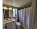 Bathroom with a modern vanity, toilet, and shower featuring a sleek shower curtain at 4883 Cherokee Rose Dr, Orlando, FL 32808