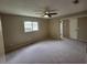 Bedroom featuring a ceiling fan, carpeted floors, and a window offering natural light and outdoor views at 4883 Cherokee Rose Dr, Orlando, FL 32808