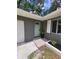 Welcoming entryway with a light blue door, brick accents, and manicured landscaping at 4883 Cherokee Rose Dr, Orlando, FL 32808