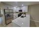 Modern kitchen boasting new stainless steel appliances, black hardware, and quartz countertop at 4883 Cherokee Rose Dr, Orlando, FL 32808