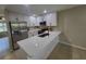 Modern kitchen featuring stainless steel appliances, white cabinets, and a sleek breakfast bar at 4883 Cherokee Rose Dr, Orlando, FL 32808