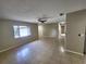 Open-concept living area with tile flooring, a ceiling fan, and plenty of natural light from the window at 4883 Cherokee Rose Dr, Orlando, FL 32808