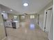 Open floor plan showcasing the modern kitchen flowing into the spacious living area with ample natural light at 4883 Cherokee Rose Dr, Orlando, FL 32808