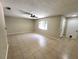 Bright living room featuring tile floors, a ceiling fan, and a window for ample natural light at 4883 Cherokee Rose Dr, Orlando, FL 32808