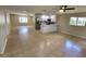 Open-concept living room and kitchen with tile floors, white cabinets and stainless steel appliances at 4883 Cherokee Rose Dr, Orlando, FL 32808