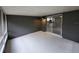 Enclosed screened patio with painted concrete floors and block walls with view to interior at 4883 Cherokee Rose Dr, Orlando, FL 32808