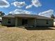 View of backyard with sliding glass doors to outdoor patio and lawn at 51 Fir Dr, Ocala, FL 34472