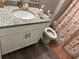 Bathroom featuring a white single sink vanity, granite countertop, and patterned shower curtain at 51 Fir Dr, Ocala, FL 34472
