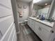 Bathroom featuring a double sink vanity, granite countertop, and shower/tub combo at 51 Fir Dr, Ocala, FL 34472