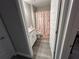 Well-lit bathroom featuring a vanity with granite countertop, white cabinets, and a shower-tub combo at 51 Fir Dr, Ocala, FL 34472