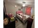 This bedroom features a ceiling fan, laminate flooring, and a pink headboard at 51 Fir Dr, Ocala, FL 34472