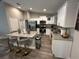 Modern kitchen with white cabinets, stainless steel appliances, and a granite island with bar seating at 51 Fir Dr, Ocala, FL 34472