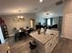 Open-concept kitchen and dining area with a granite island and a view into the living room at 51 Fir Dr, Ocala, FL 34472