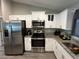 Bright kitchen featuring stainless steel appliances, granite countertops, and ample cabinet space at 51 Fir Dr, Ocala, FL 34472