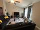 Comfortable living room featuring vaulted ceiling, ceiling fan, large sofa, and patterned area rug at 51 Fir Dr, Ocala, FL 34472