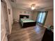 Relaxing main bedroom features a ceiling fan, ensuite bathroom, and laminate flooring at 51 Fir Dr, Ocala, FL 34472